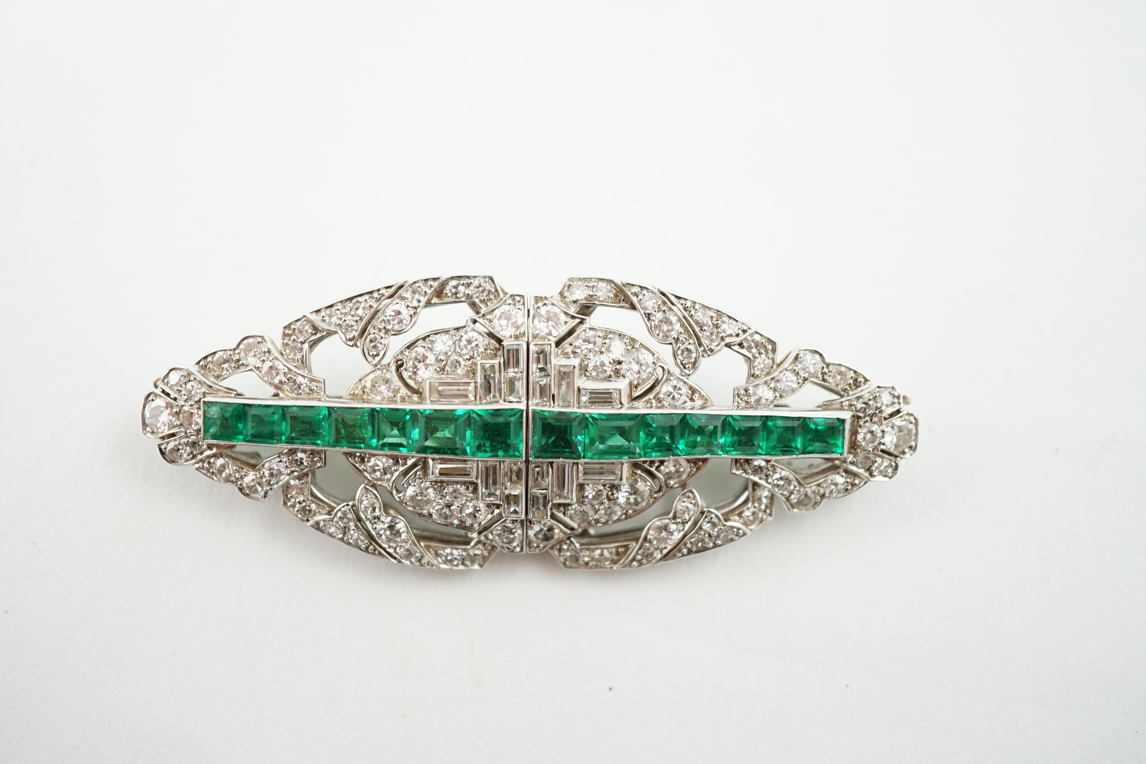 A 1930's/1940's white gold, emerald and diamond double clip brooch